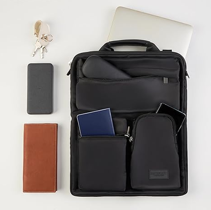 Black over-luggage organizer bag laid flat with passport, phone, wallet and tablet in its front pockets