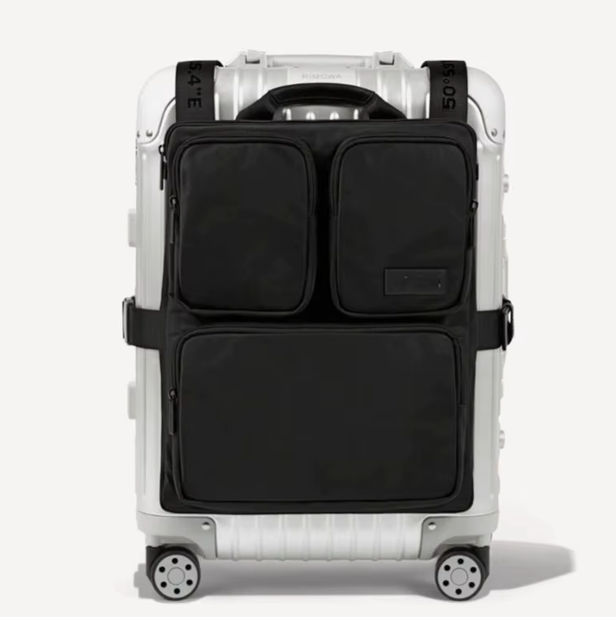 Front of a silver aluminum suitcase fitted with the black luggage handle hanging bag and its four pockets