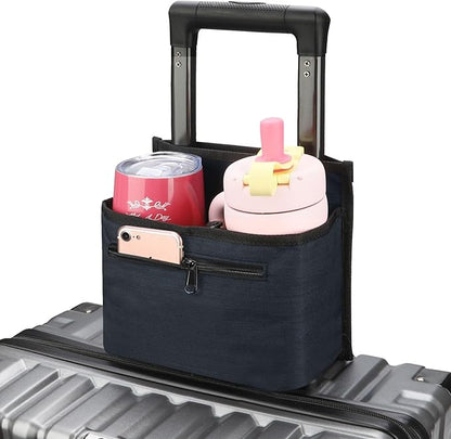 Navy luggage cup holder on a suitcase handle holding a pink tumbler, a red can and a phone in the front pocket