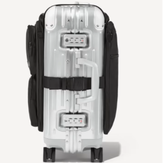 Back of a silver aluminum suitcase showing the adjustable straps that secure the luggage organizer bag